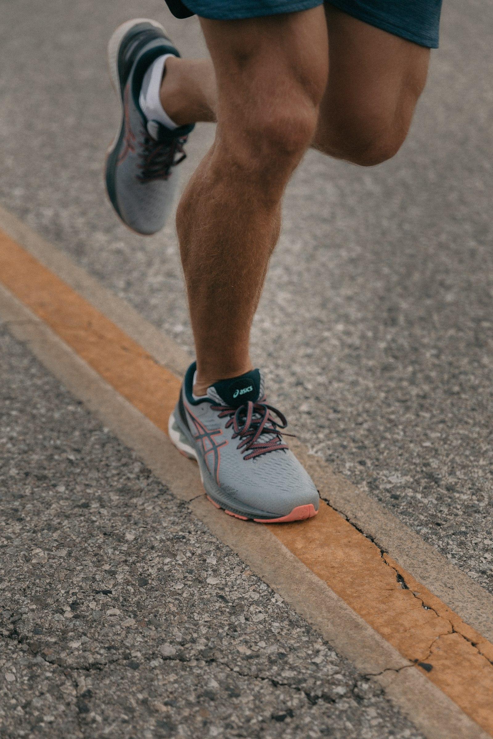 A runner mid-stride, captured close on the feet and lower legs